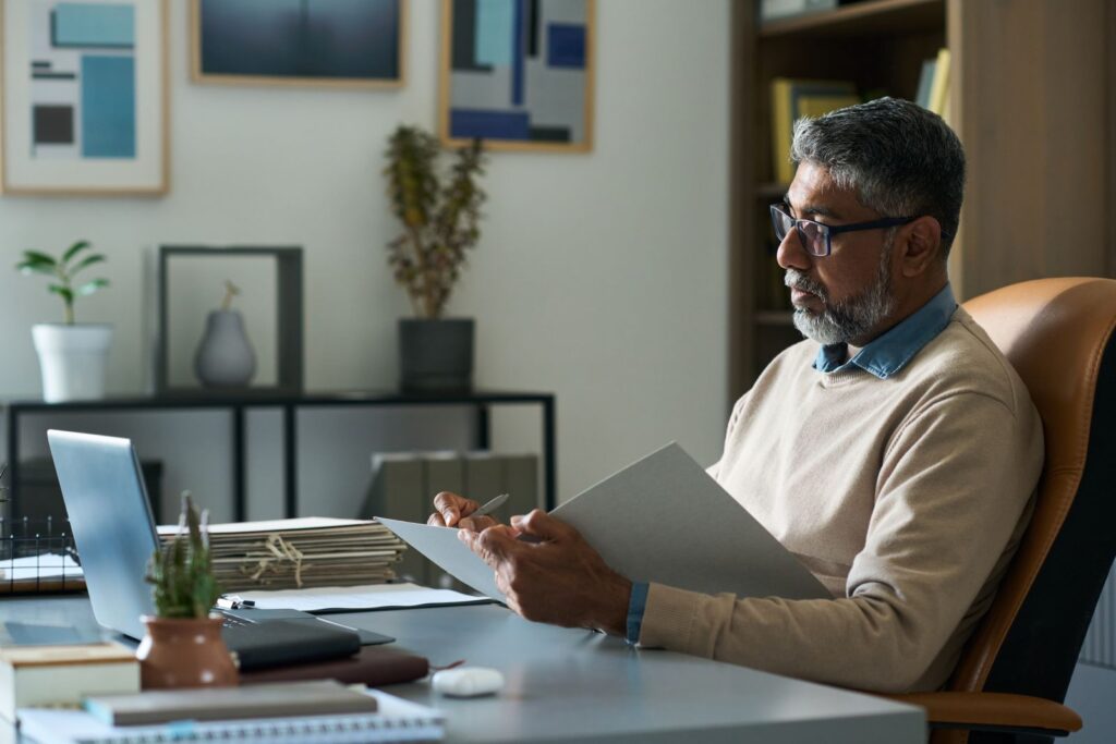 Caribbean business leader reviewing an AI governance document in an office setting