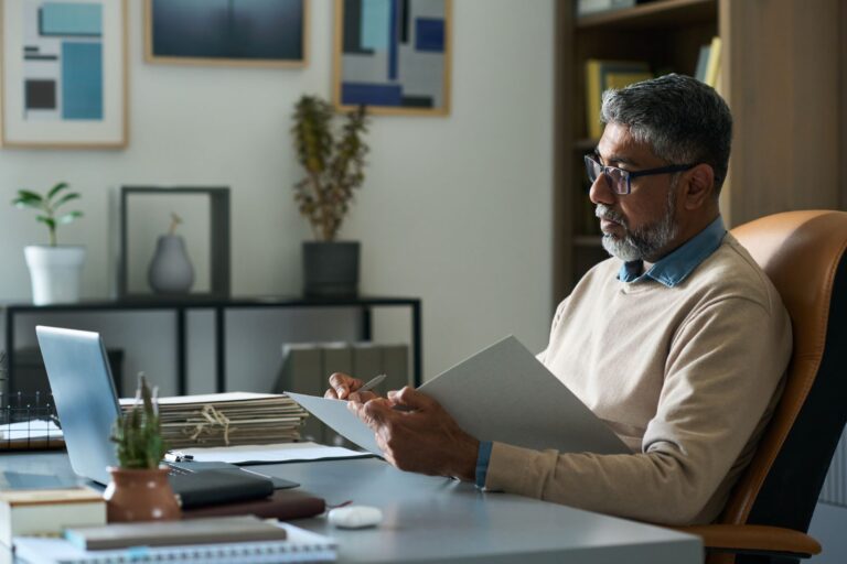 Caribbean business leader reviewing an AI governance document in an office setting